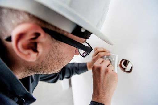 a plumber performing sump pump maintenance.