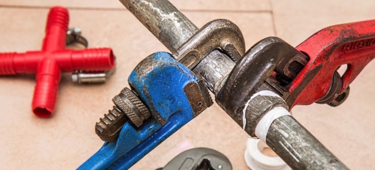 Pipe wrenches used for managing plumbing emergencies.