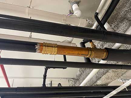 Burst pipe repair in Darien Illinois with technician fixing broken water pipe