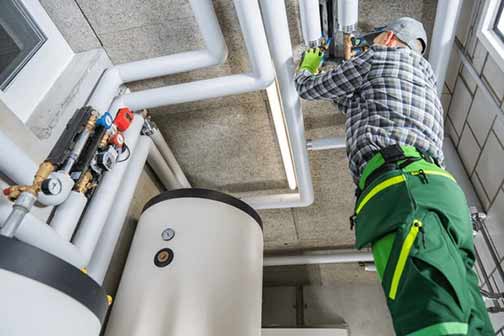 a commercial plumber repairing business plumbing issues.