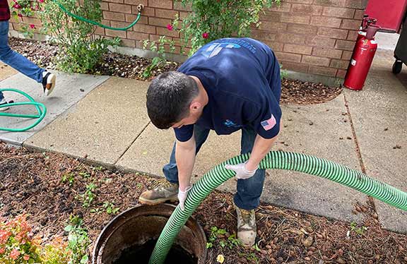a technician cleaning out a catch basin in chicago area