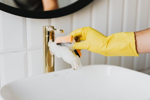 a person cleaning a sink.