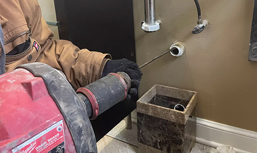 a plumber performing a drain cleaning