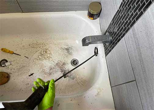 a plumber performing drain cleaning services in downers grove.