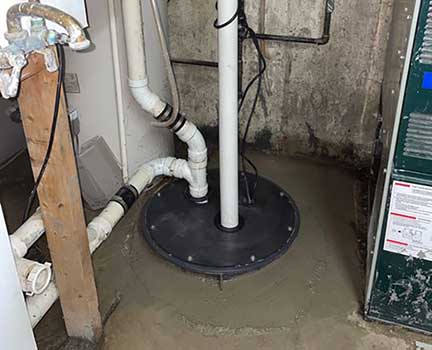 Ejector pump replacement in Brookfield Illinois showing basement plumbing system installation