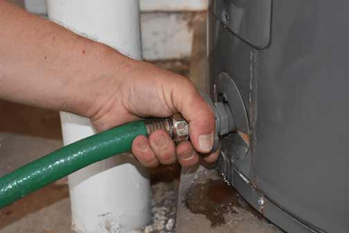 a man flushing out his water heater
