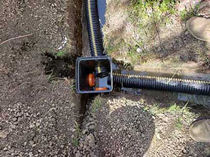 French drain installation Orland Park Illinois yard water drainage system trenching and gravel placement