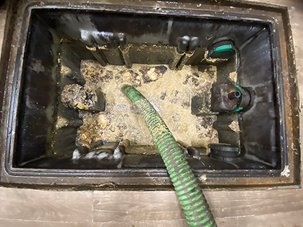 Grease trap cleaning in Bridgeview Illinois showing commercial kitchen maintenance service