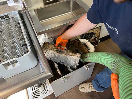 Grease trap cleaning service in Oak Brook Illinois showing commercial plumbing maintenance work