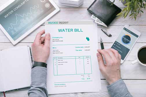 a person reading a high water bill.