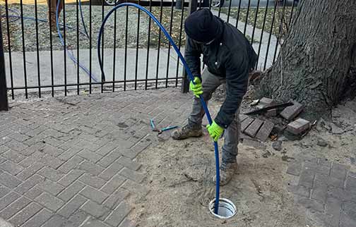 a plumber performing a hydro jet cleaning