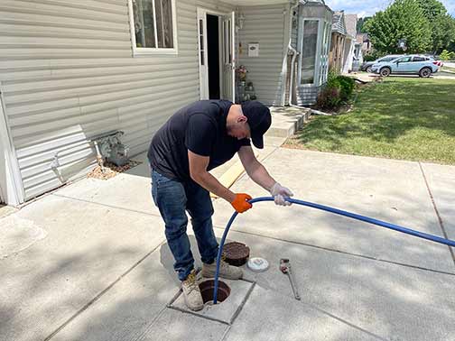 a plumber performing a hydro jetting cleaning