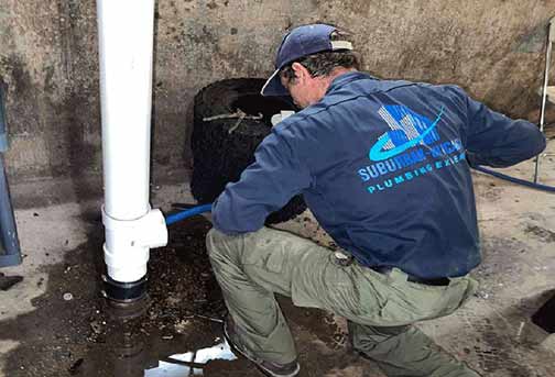 a hydro jetting plumber cleaning out a sewer line