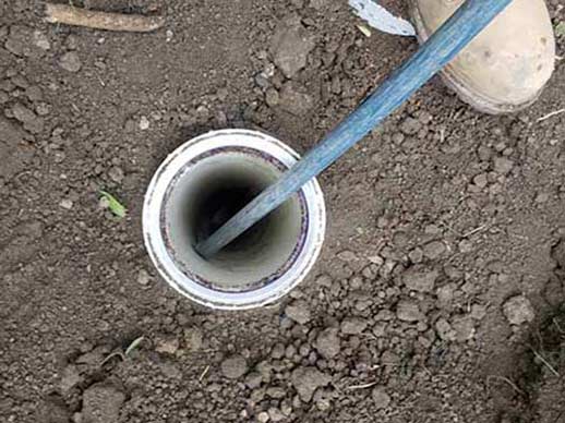 a hydro jetting being performed to blast away tree roots.