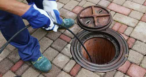 a plumber performing a hydro jetting to clear a blockage.