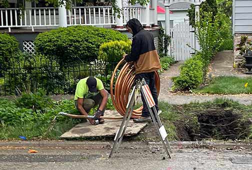 professional plumbers installing a new water line in chicago