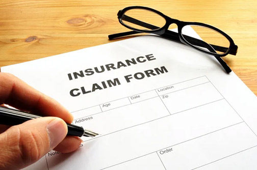 a person filling out an insurance claim