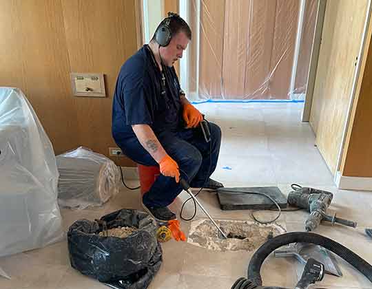 a plumber performing a leak detection service.