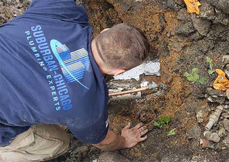 a plumber performing a main water line repair in la grange.