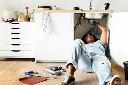 a lady mastering the art of plumbing.