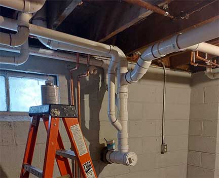 Overhead sewer system installation in Riverside Illinois protecting basement from sewer backup