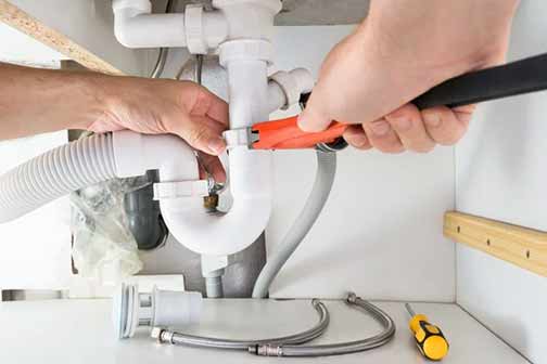 a plumber replacing leaky pipes.