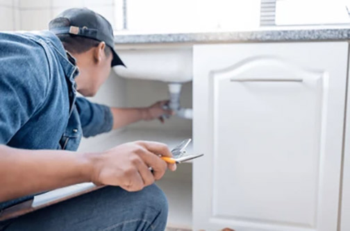 a plumber in westmont illinois performing a plumbing check