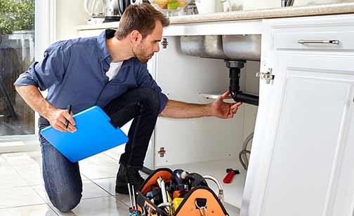 a professional plumber performing a plumbing inspection