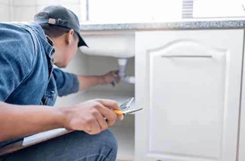 a plumber performing a plumbing inspection in illinois