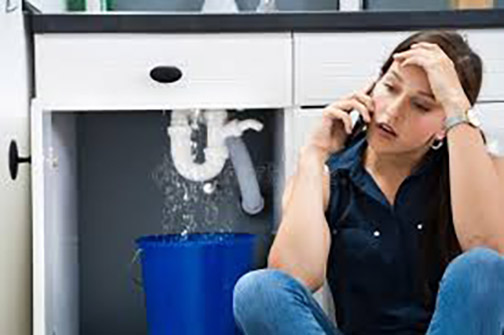 a woman with plumbing leaks in her home