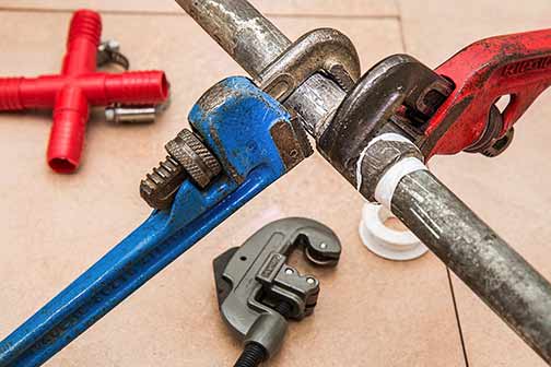 plumbing tools to repair a burst pipe.