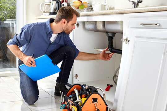 a plumber inspecting a customers drain pipes