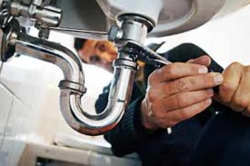 a professional plumber making an emergency plumbing repair.