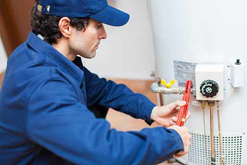 a professional plumber making water heater repairs