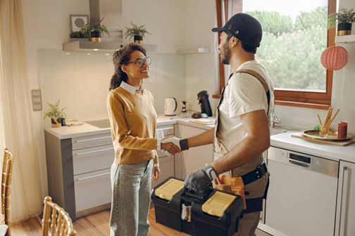 a woman thanking her plumber for a job well done