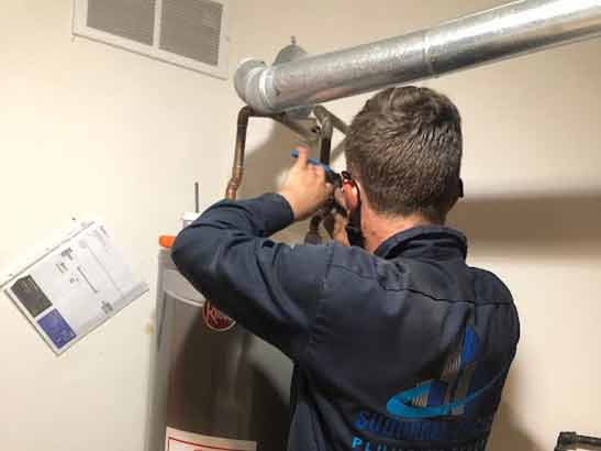 our plumber repairing a customers broken water heater.