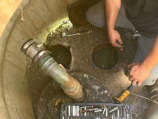 a plumber repairing a sewage pipe leak