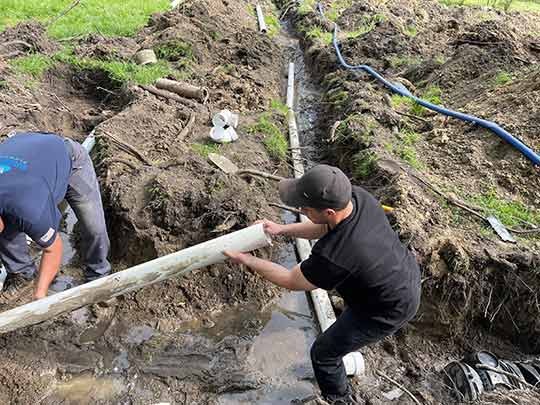 plumbers replacing a broken sewer line in chicago.