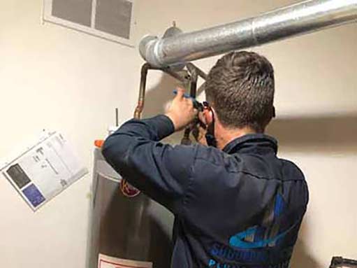 a plumber replacing a water heater in willowbrook illinois.