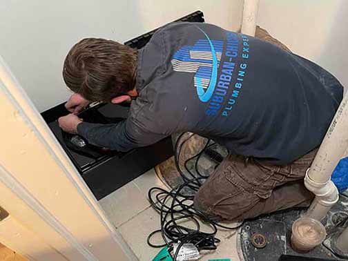 a professional plumber replacing a sump pump