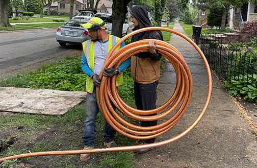 plumbers replacing a main water line.