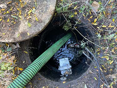 a septic tank being pumped out