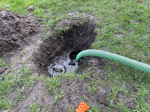 a septic tank pumping being performed.