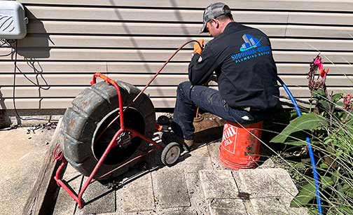 a professional performing a sewer camera inspection
