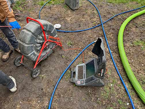 a plumber performing a sewer camera inspection