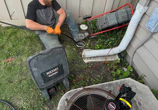 a plumber performing a sewer line inspection in summit illinois.