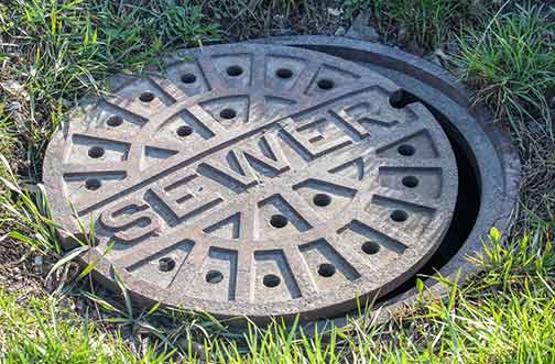 a manhole cover with sewer written on it