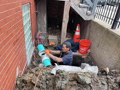 a plumber making a sewer line repair