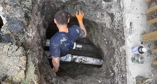 a plumber performing a sewer line repair