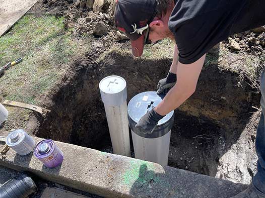 a plumber performing a sewer line repair in naperville il.